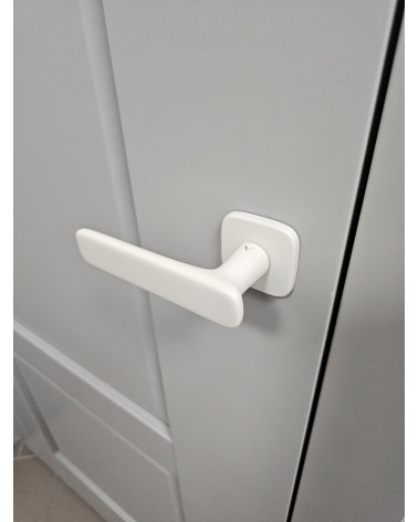 FLOW matt ivory door handle design handle top view mounted on a door