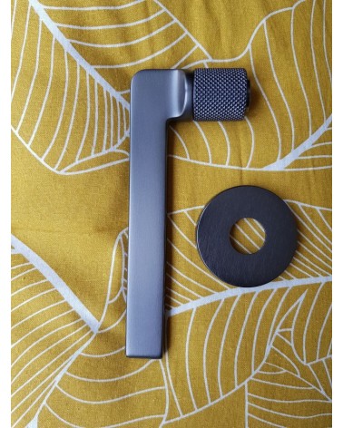 Mandelli Grint door handle designer handle colour 5 side view on a patterned background