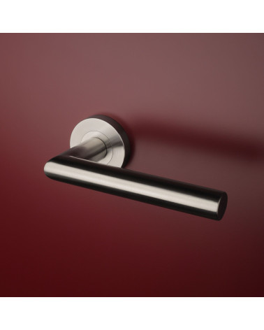 Stainless steel colour oval door handles on red background