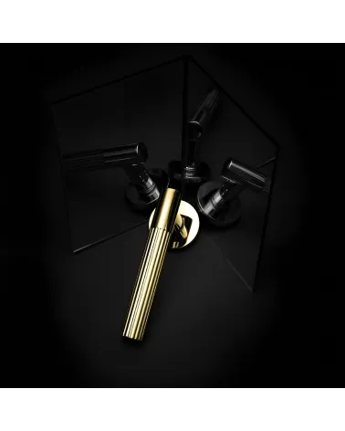 Polished gold LIVIA door handle designer handle presented with mirror reflections