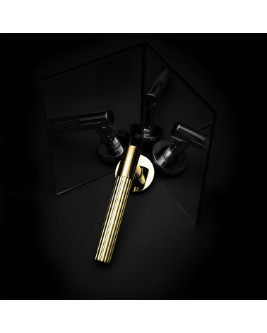 Polished gold LIVIA door handle designer handle presented with mirror reflections
