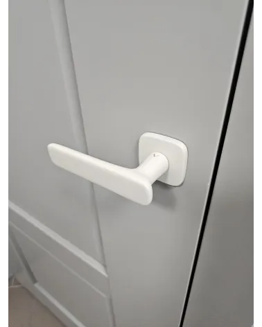 Modern FLOW door handle design handle inclined view mounted on a door