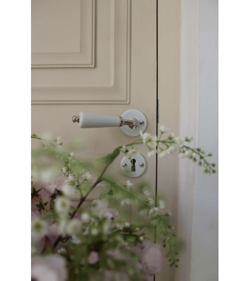 Barrel door handle on white porcelain rose - nickel finish - designer handle