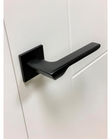LIGNE black door handle design handle angled top view mounted on a door