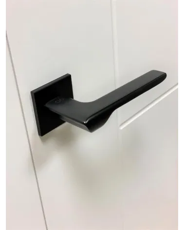 LIGNE black door handle design handle angled top view mounted on a door