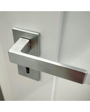 Brushed chrome Apollo door handle designer handle angled top view mounted on a door