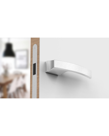 Satin chrome Arc door handle designer handle bottom view mounted on a door