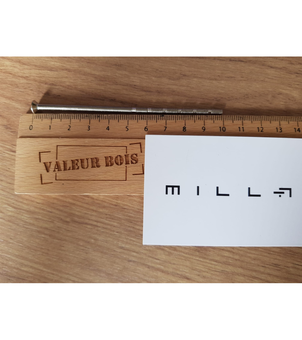 M4 through-threaded rod 10cm long on a table, with a wooden ruler and white millapoignees business card