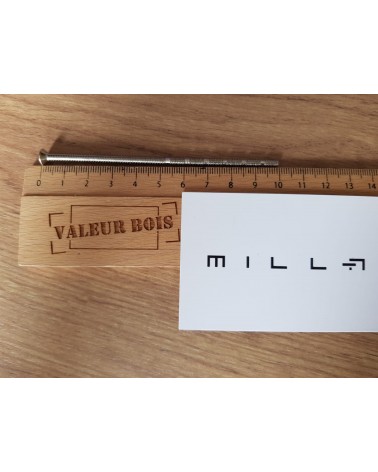 M4 through-threaded rod 10cm long on a table, with a wooden ruler and white millapoignees business card