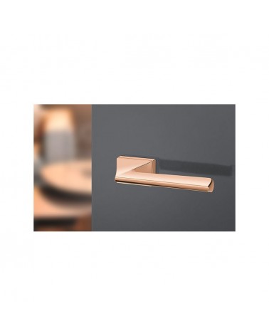 Copper door handle Impera designer handle angled top view mounted on a door