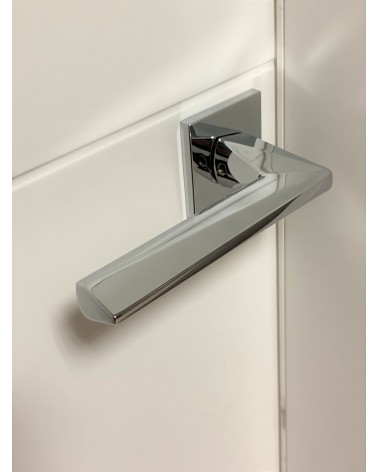 Polished chrome DIAMANT door handle designer handle angled top view mounted on a door