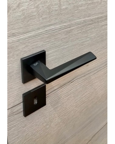 Black DIAMANT door handle designer handle angled top view mounted on a door