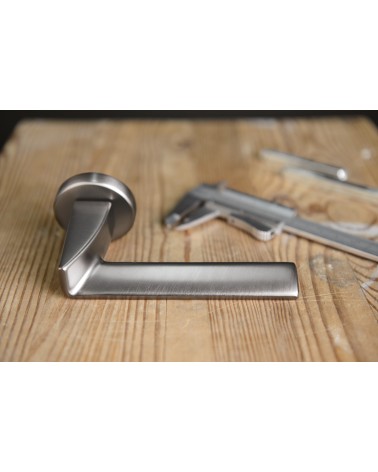 Polished chrome Ento Edge door handle designer handle side view mounted on a plate