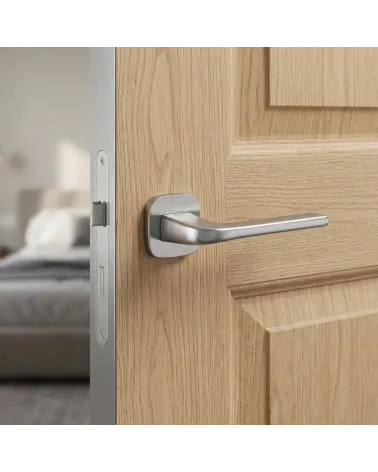 Solo door handle on rounded plate brushed chrome finish