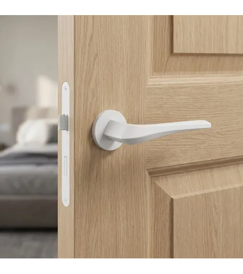 Matt white FLOW door handle on round rosette - designer handle