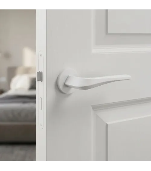 Matt white FLOW door handle on round rosette - designer handle