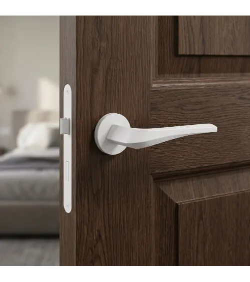 Matt white FLOW door handle on round rosette - designer handle