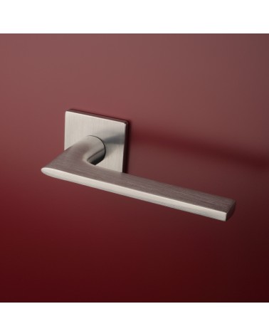 Brushed chrome SALVIA door handle designer handle fitted on a door