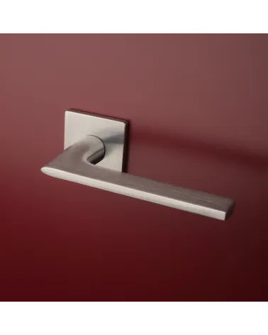 Brushed chrome SALVIA door handle designer handle fitted on a door