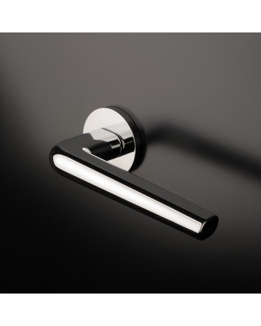 Polished chrome FUNKIA door handle designer handle mounted on a door
