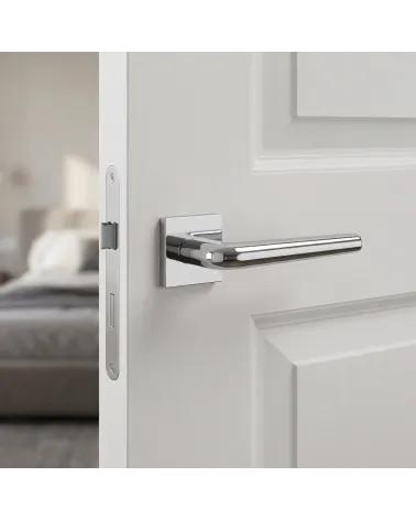 Elegant FUNKIA polished chrome door handle on square backplate.