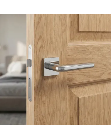Elegant FUNKIA polished chrome door handle on square backplate.