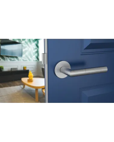 Satin chrome ARABIS door handle designer handle angled top view mounted on a door