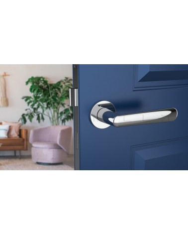 Polished chrome door handle ARIA designer handle front view mounted on an ajar door