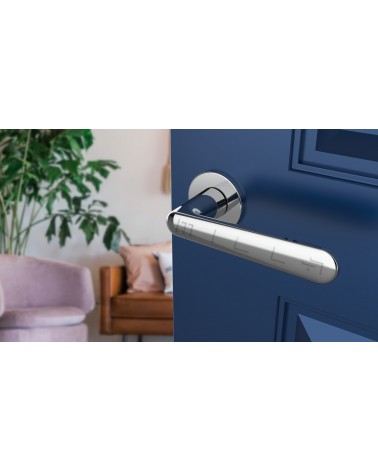 Polished chrome door handle ARIA designer handle angled top view mounted on a door