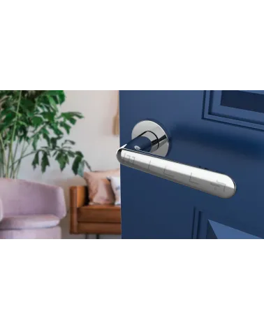 Polished chrome door handle ARIA designer handle angled top view mounted on a door