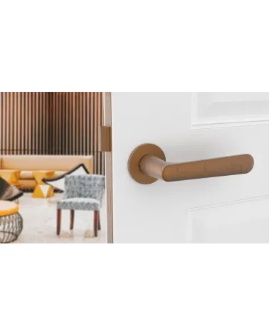 Copper ARIA design door handle front view mounted on a door