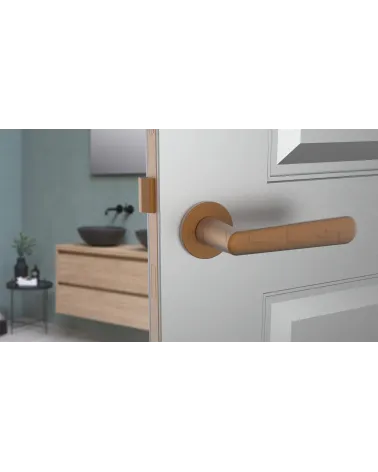 Copper ARIA design door handle front view mounted on an ajar door