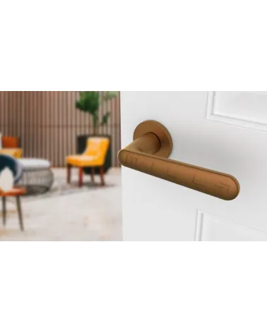 Copper ARIA design door handle angled top view mounted on a door