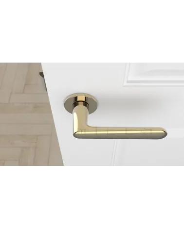 Polished gold ARIA designer door handle top view mounted on a door