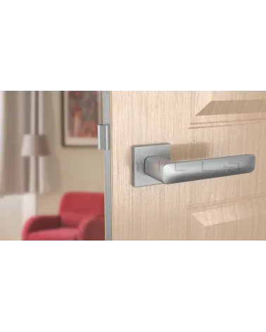 Satin chrome STELLA door handle design handle front view mounted on a door