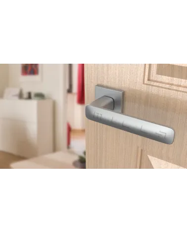Satin chrome STELLA door handle design handle angled top view mounted on a door
