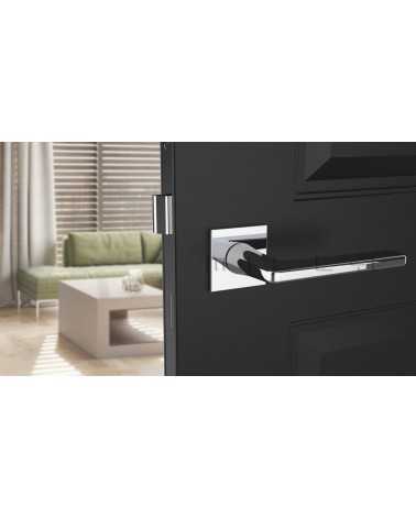 Polished chrome SETIA door handle design handle front view mounted on a door