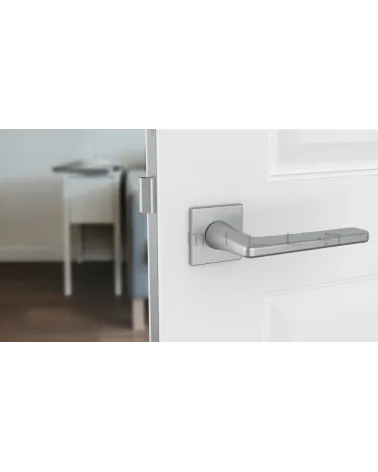 Satin chrome SETIA designer door handle front view mounted on a door