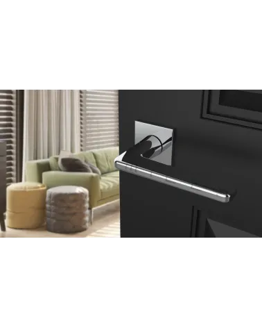 Contemporary SETIA designer door handle angled top view mounted on a door