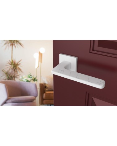 White YUKA door handle designer ironmongery angled view mounted on a door