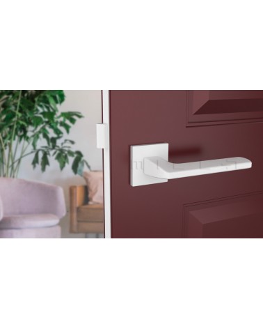 White YUKA door handle designer ironmongery front view mounted on a door