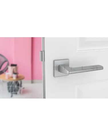 YUKA satin chrome door handle designer hardware front view mounted on a door