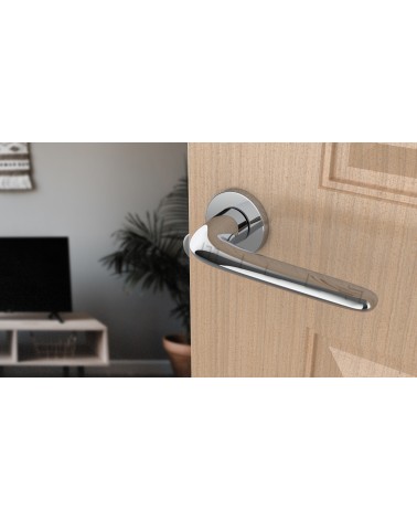 AZALIA polished chrome door handle designer handle angled view mounted on a door