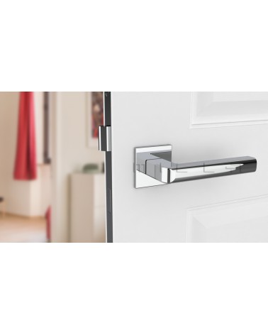 Polished chrome SALICE door handle design hardware front view mounted on a door