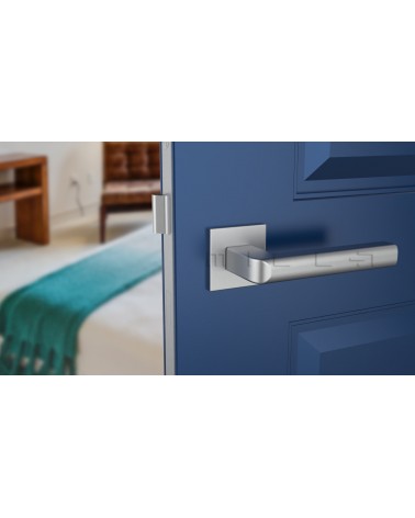 Satin chrome SALICE door handle designer ironmongery front view mounted on a door
