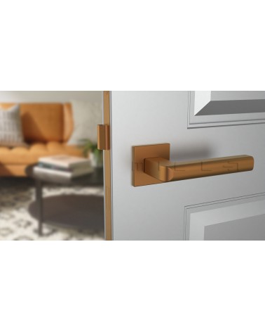 Copper SALICE door handle designer ironmongery front view mounted on a door