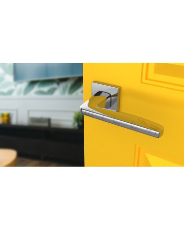 ERBA polished chrome door handle design handle angled view mounted on a door