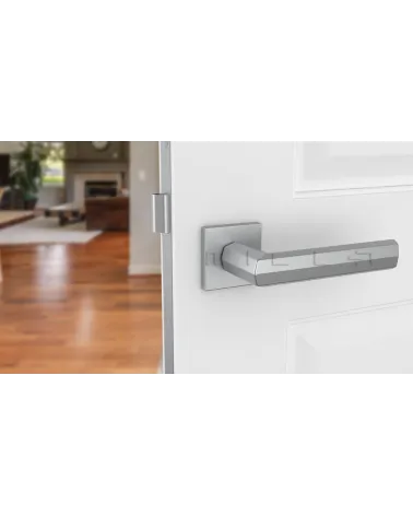 Satin chrome FRESIA door handle designer handle front view mounted on a door
