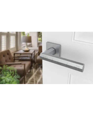 Satin chrome FRESIA door handle designer handle angled view mounted on a door