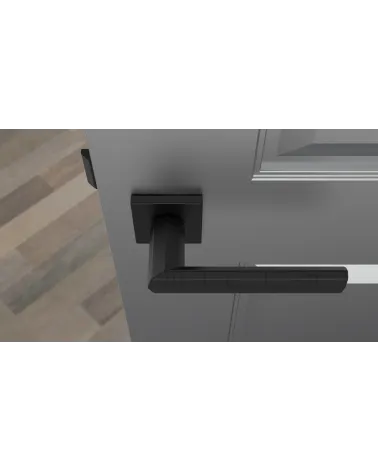 Black FRESIA door handle designer handle top view mounted on a door